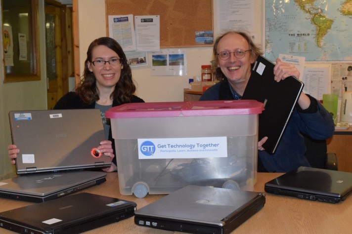 Picture shows laptop donations being given to GTT